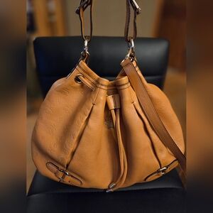 Authentic MCM Leather Drawstring Bucket Bag, often referred as Hobo Crossbody